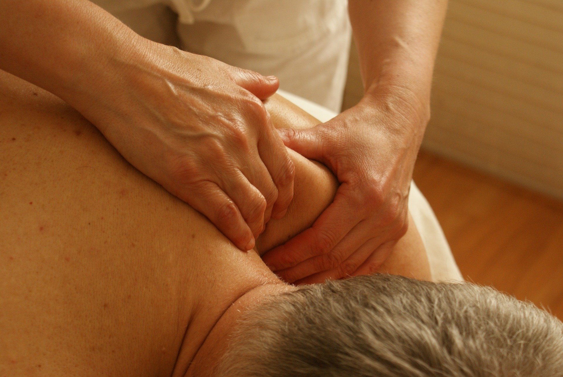 therapist performing shoulder massage on patient