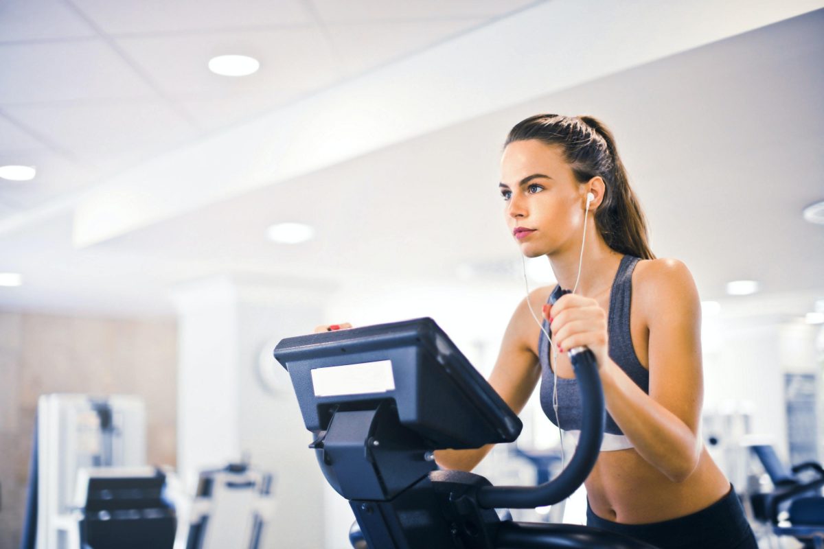 A woman using an elliptical, a great low impact cardio alternative to running