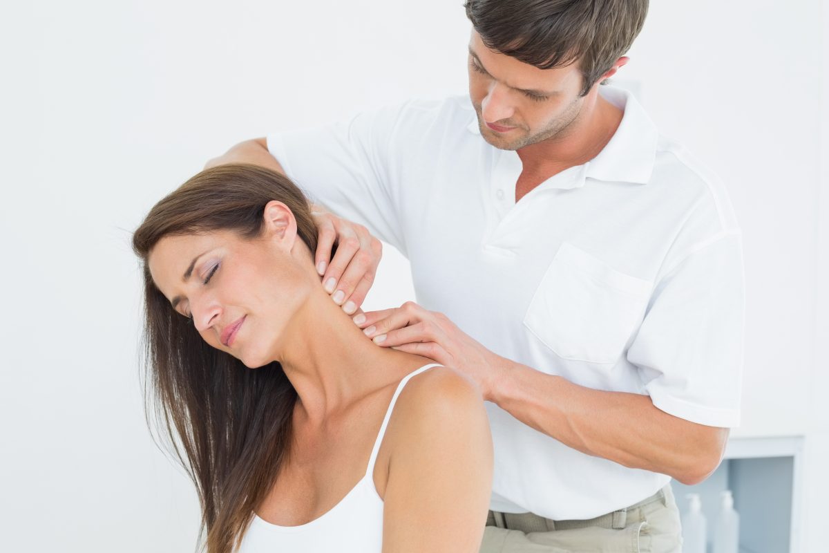 Chiropractor treating a patient's neck.