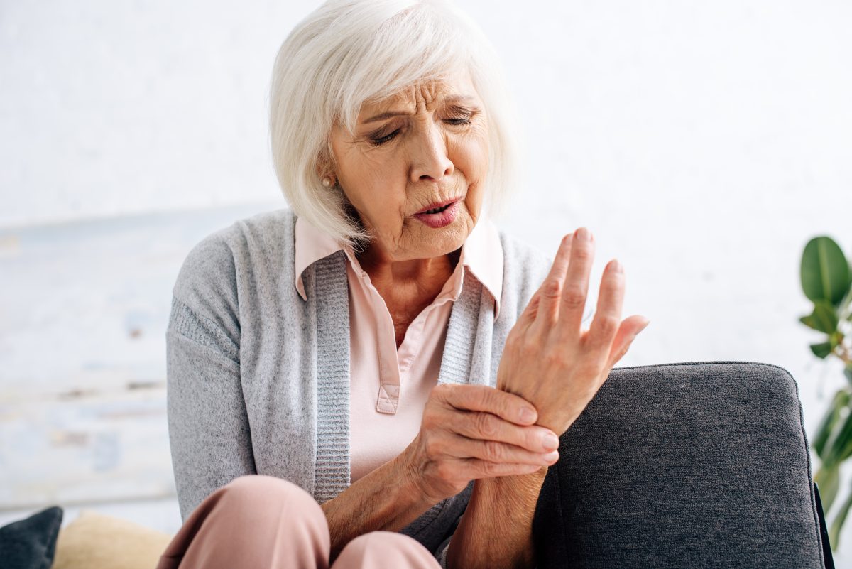 senior woman with arthritis in hand