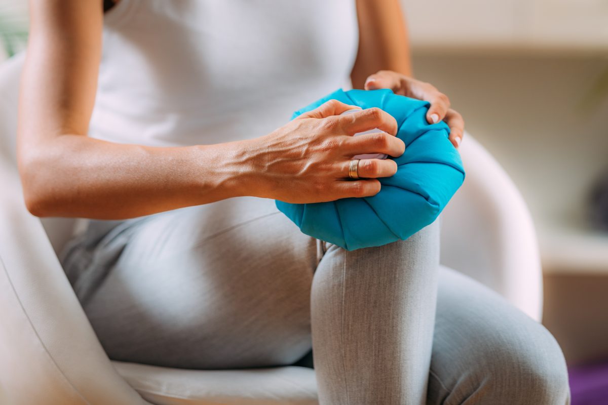 woman holding ice pack on her knee