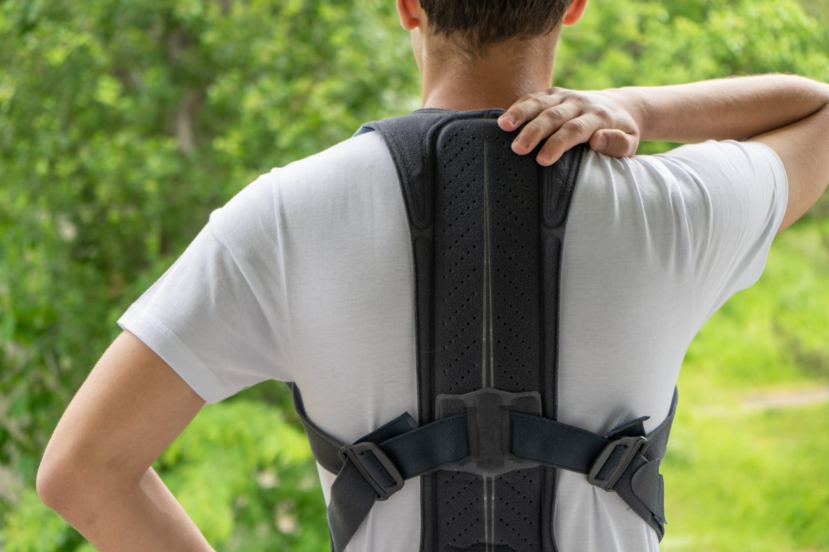 Closeup of man wearing posture corrector to straighten his spine