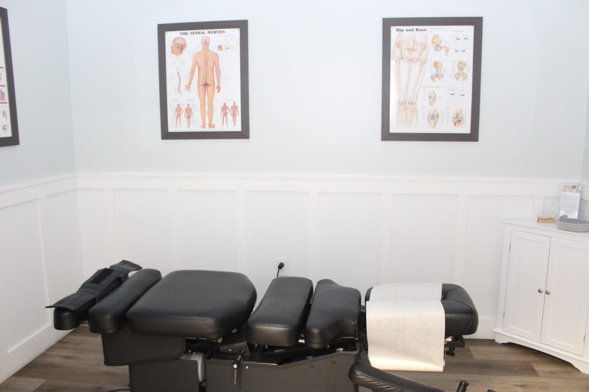 chiropractic adjustment table in a treatment room