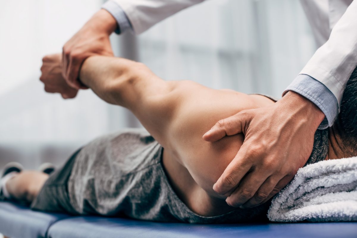 closeup of chiropractor shoulder adjustment