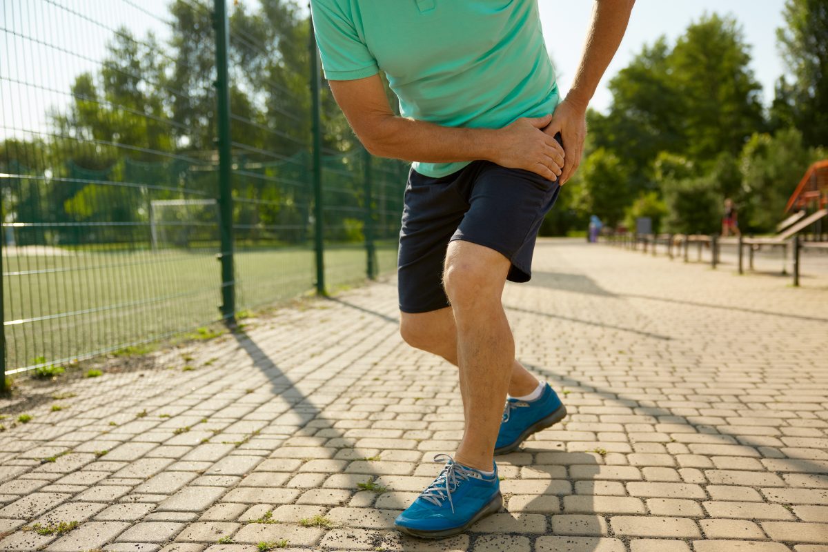 man holding onto hip