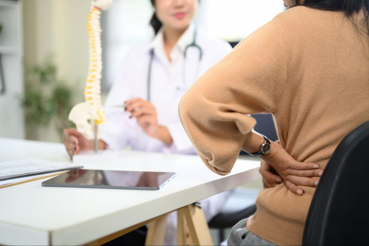 Doctor explaining treatment to patient with back pain